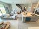 Open-concept design featuring a kitchen island, a comfortable living area, and a dining space near the stairs at 107 Grove St, Orlando, FL 32835