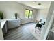 Brightly lit loft space featuring grey cabinets and countertop, vinyl floor, and modern decor at 107 Grove St, Orlando, FL 32835