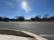 A beautiful sunny day showing a street with trees in the background under a bright blue sky at 107 Grove St, Orlando, FL 32835
