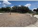 A set of swings in a park with benches around the perimeter on a sunny day at 107 Grove St, Orlando, FL 32835