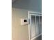 Close up of a wall-mounted thermostat and HVAC system panel, providing climate control convenience at 107 Grove St, Orlando, FL 32835