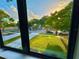 Bright view from a window overlooking a green lawn and a quiet residential street at 107 Grove St, Orlando, FL 32835
