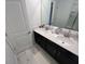 Dual sink bathroom with white countertops and black cabinets at 1078 Splash Shot Pl, Davenport, FL 33896