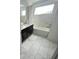 Modern bathroom with double sinks, dark cabinets, a tub, and marble-like tile at 1078 Splash Shot Pl, Davenport, FL 33896