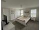 Well-lit bedroom with plush bedding and contemporary furnishings, including a TV at 1078 Splash Shot Pl, Davenport, FL 33896