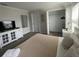 Well-lit bedroom with plush bedding and contemporary furnishings, including a TV and open closet at 1078 Splash Shot Pl, Davenport, FL 33896