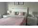 Comfortable bedroom with modern decor, featuring a cozy bed with two side tables at 1078 Splash Shot Pl, Davenport, FL 33896