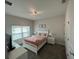 Bedroom with a neutral color scheme featuring a double bed, a TV, and bedside lamps at 1078 Splash Shot Pl, Davenport, FL 33896