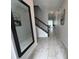 Bright hallway with staircase and modern tile flooring at 1078 Splash Shot Pl, Davenport, FL 33896