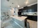 Spacious kitchen featuring dark cabinetry, stainless appliances, and a large island with a sink at 1078 Splash Shot Pl, Davenport, FL 33896
