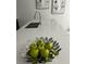 Close-up of kitchen island with stainless steel sink and decorative fruit at 1078 Splash Shot Pl, Davenport, FL 33896