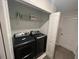 Washer and dryer inside laundry closet with shelving at 1078 Splash Shot Pl, Davenport, FL 33896