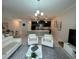 Inviting living area featuring modern decor, tile flooring, and seamless flow to the kitchen at 1078 Splash Shot Pl, Davenport, FL 33896