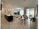 Bright, open-concept living space with modern tile floors, a sleek kitchen island, and a dining area at 1078 Splash Shot Pl, Davenport, FL 33896