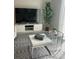 Modern living room with stylish furniture, a patterned rug, and a view of a large screen TV at 1078 Splash Shot Pl, Davenport, FL 33896