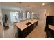 Open living space featuring a modern kitchen, dining area, and stylish living room furniture at 1078 Splash Shot Pl, Davenport, FL 33896
