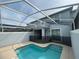 Backyard pool with screen enclosure, view of the two-story home at 1078 Splash Shot Pl, Davenport, FL 33896