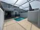 Private screened-in pool area with a safety fence and modern patio at 1078 Splash Shot Pl, Davenport, FL 33896