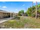 Backyard featuring a shed, covered outdoor kitchen, and grassy space at 110 S Edgemon Ave, Winter Springs, FL 32708