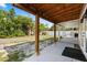 View of a spacious backyard with a covered patio area and a large grassy space at 110 S Edgemon Ave, Winter Springs, FL 32708