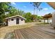 A storage shed is located in the grassy backyard with some trees for shade at 110 S Edgemon Ave, Winter Springs, FL 32708