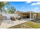 Cozy backyard with seating around a firepit and a covered outdoor dining area at 110 S Edgemon Ave, Winter Springs, FL 32708