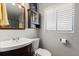 Small bathroom featuring a wood vanity, mirror, and window at 110 S Edgemon Ave, Winter Springs, FL 32708