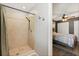 Bathroom with walk-in tiled shower and adjacent bedroom area at 110 S Edgemon Ave, Winter Springs, FL 32708