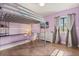This bedroom has a stylish lofted bed with a built-in desk and a cute pink chair at 110 S Edgemon Ave, Winter Springs, FL 32708