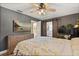 Comfortable bedroom featuring hardwood floors, a barn-style sliding door, and a wall-mounted TV at 110 S Edgemon Ave, Winter Springs, FL 32708
