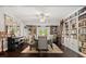 Elegant dining room with built-in bookshelves, chandelier, and a grand piano creates a sophisticated ambiance at 110 S Edgemon Ave, Winter Springs, FL 32708