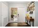 Warm entryway with stylish decor, featuring a console table, decorative signs, and a view to the backyard at 110 S Edgemon Ave, Winter Springs, FL 32708