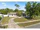 Charming single-story home with a curved driveway and lush front yard landscaping, inviting curb appeal at 110 S Edgemon Ave, Winter Springs, FL 32708