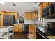 Well-lit kitchen boasts stainless steel appliances, granite countertops, and wooden cabinets at 110 S Edgemon Ave, Winter Springs, FL 32708