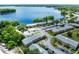 Aerial view of lakeside apartments featuring brick facades, ample parking, and mature trees at 117 Georgetown Dr # C, Casselberry, FL 32707