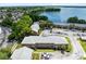 Aerial view of a brick apartment complex situated near a lake with ample parking at 117 Georgetown Dr # C, Casselberry, FL 32707