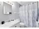 Bathroom features a vanity, toilet, shower with tree-patterned curtain, and modern hardware at 117 Georgetown Dr # C, Casselberry, FL 32707