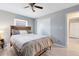 Bedroom showcases wood-look floors, a ceiling fan, and a sliding-door closet for storage at 117 Georgetown Dr # C, Casselberry, FL 32707