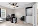 Bedroom featuring a desk with monitors, in-room laundry, wood-look flooring and ceiling fan at 117 Georgetown Dr # C, Casselberry, FL 32707