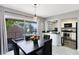Dining room with sliding door to balcony and views of the kitchen through a pass-through window at 117 Georgetown Dr # C, Casselberry, FL 32707