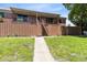 Two-story brick apartment complex with stairway leading to upper units and green grass at 117 Georgetown Dr # C, Casselberry, FL 32707