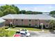 Exterior view of a two-story brick apartment complex with green shutters and lawn at 117 Georgetown Dr # C, Casselberry, FL 32707