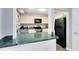 Well-maintained kitchen featuring white cabinets, a breakfast bar, and stainless-steel appliances at 117 Georgetown Dr # C, Casselberry, FL 32707