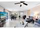 Bright living room with luxury vinyl plank flooring, ceiling fan, and access to kitchen at 117 Georgetown Dr # C, Casselberry, FL 32707