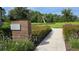 Lush Active Park with a walking path leading to play structures in a green space at 12009 Walmsley Aly, Winter Garden, FL 34787