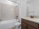 Bathroom with granite vanity, tiled shower and tub, plus a neutral color palette at 12009 Walmsley Aly, Winter Garden, FL 34787