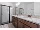 Bathroom featuring dual vanity sinks with granite countertops and a tiled shower at 12009 Walmsley Aly, Winter Garden, FL 34787