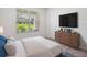 Well-lit bedroom with a view, featuring neutral decor and ample natural light at 12009 Walmsley Aly, Winter Garden, FL 34787