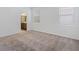 Minimalistic bedroom with carpeted floors, abundant natural light, and ensuite bathroom access at 12009 Walmsley Aly, Winter Garden, FL 34787