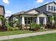 Attractive home featuring a covered entryway, well-kept lawn, and tasteful landscaping at 12009 Walmsley Aly, Winter Garden, FL 34787
